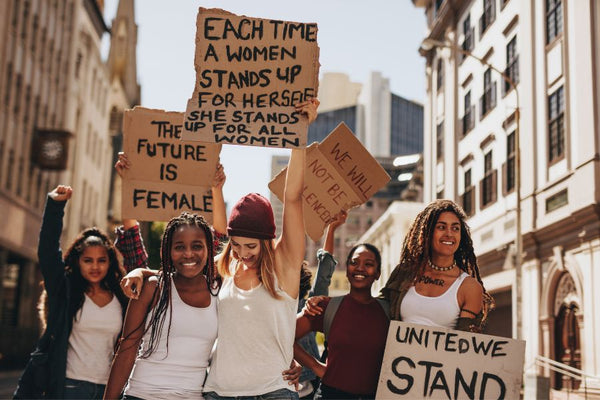 A group of women participating in a feminist protest, united for gender equality and advocating for education on women's rights.