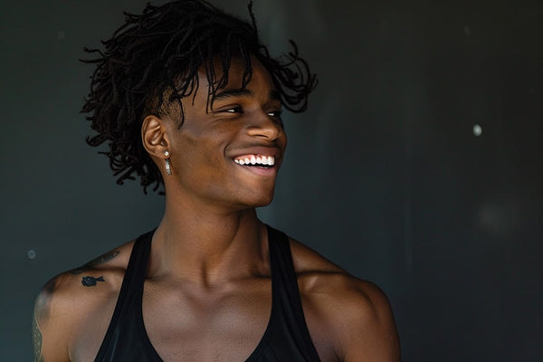 Masculine trans man from a vibrant and diverse community, each expressing happiness and exuding confidence with proud stances. Wearing black chest binders, they showcase the importance of comfort and support in their journeys. This image highlights the solidarity and strength within the trans man community, celebrating their shared experiences and diverse identities.