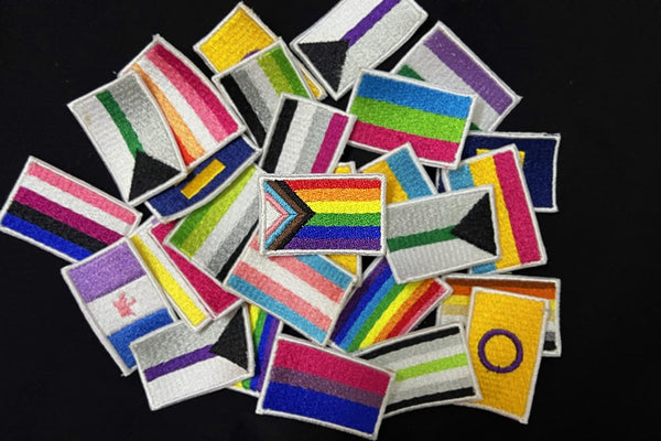 An embroidery showcasing various pride flags, each representing different LGBTQ+ communities and identities.