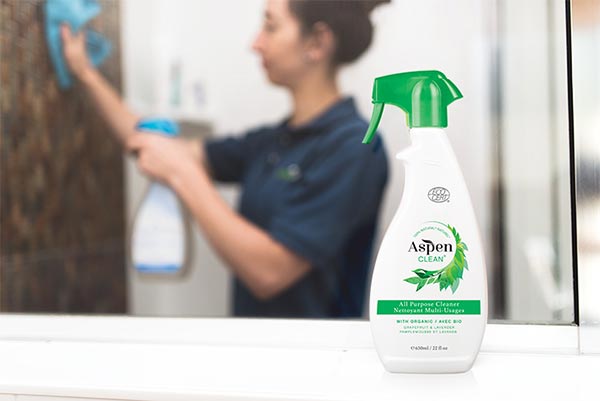 AspenClean professional cleaner is using the AspenClean all purpose cleaner to clean the house