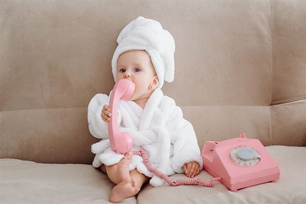 Baby with a pink telephone