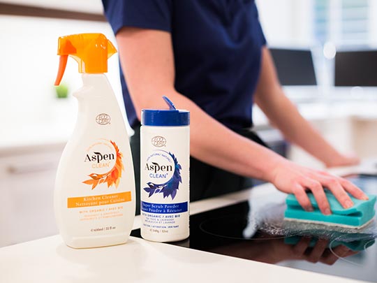 Woman is using AspenClean Oven and Stove top Cleaner Kit