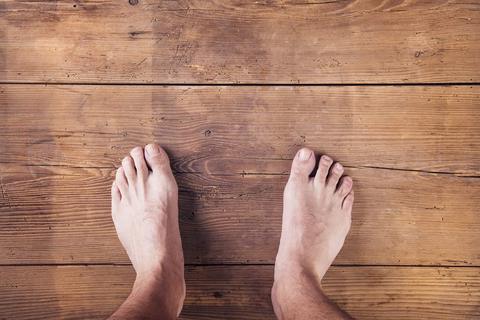 Bare foot on the hardwood floor 