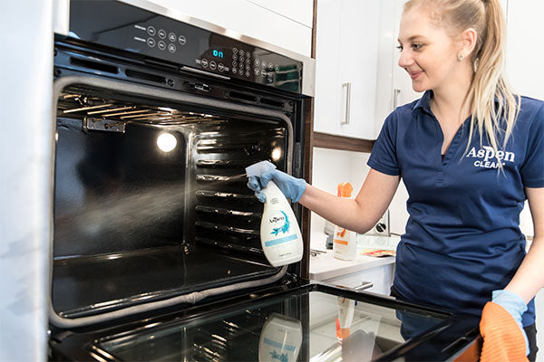 AspenClean professional cleaner is using the AspenClean oven cleaner to clean the oven