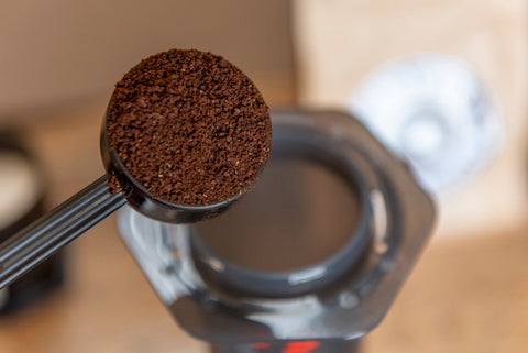 Placing scoop of coffee in AeroPress