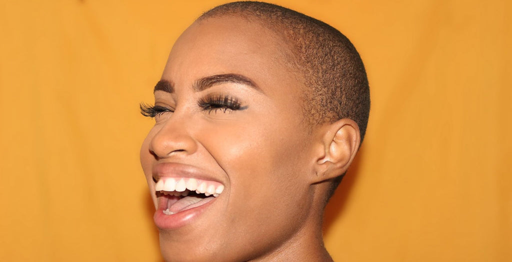 shaved head happy woman laughing 