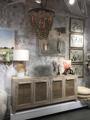 pretty display at market with sideboard and pillows and chandelier