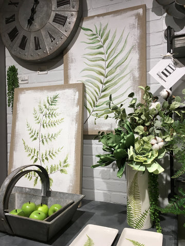 Showroom display with fern prints and wall clock