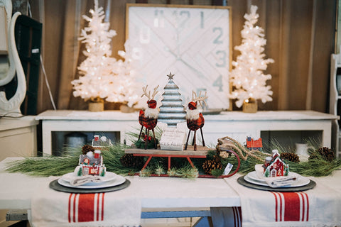 table setting with red stripe runners and lighted white trees