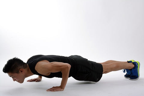 man doing push up as muscle building exercise at home