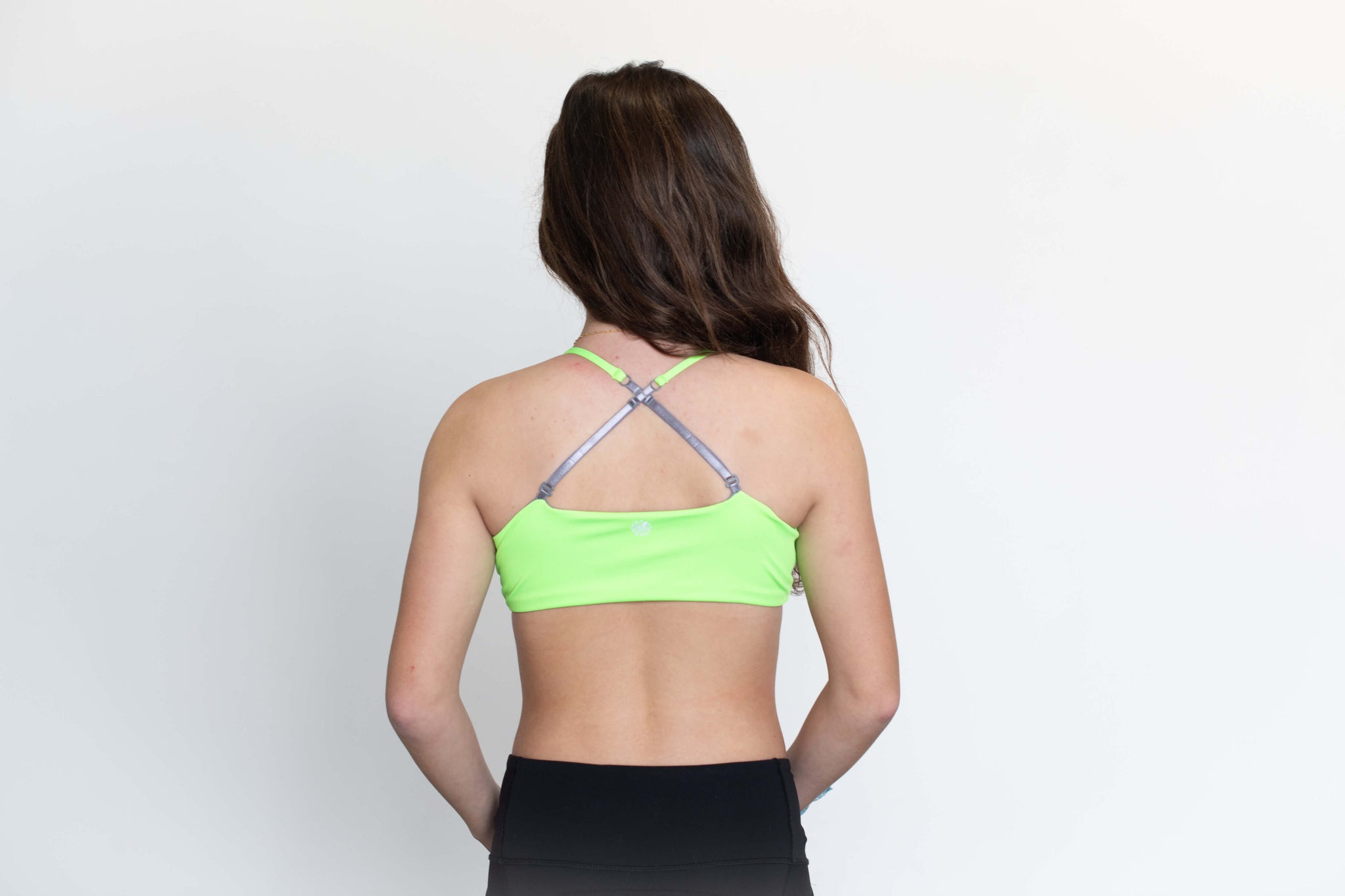 Teen girl wears neon green sports bra from Bleuet.