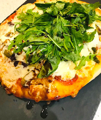 pizza dough with prosciutto and arugula