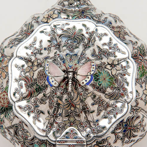 Detail of butterfly finial and lid of the teapot on the tête-a-tête service in Fig 5