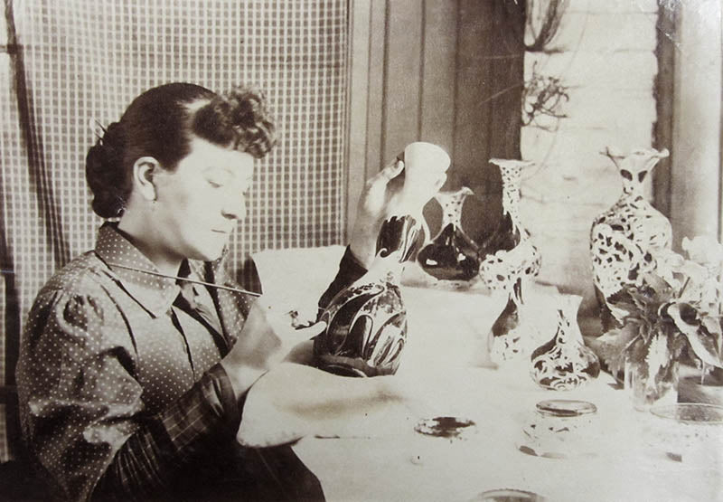 A woman decorating a 2020 model vase with floral decoration.  Photo courtesy Porvidence Public Library