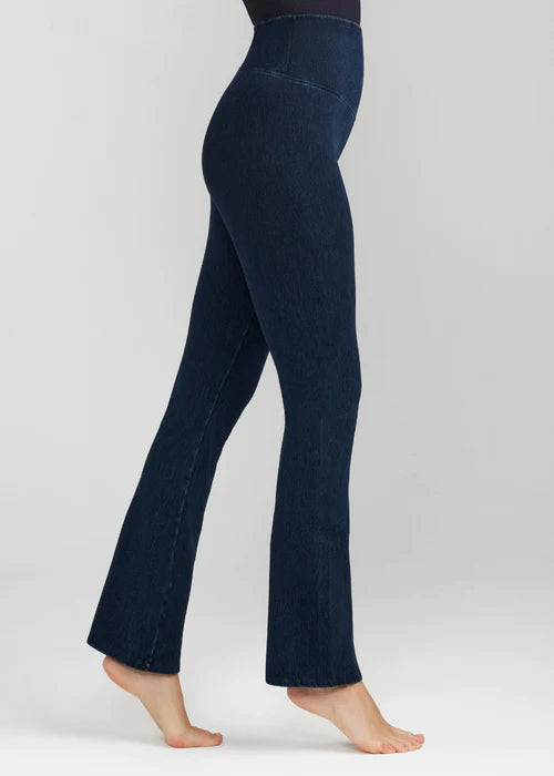 denim bootcut shaping legging in True Indigo worn by a woman standing sideways Yummie