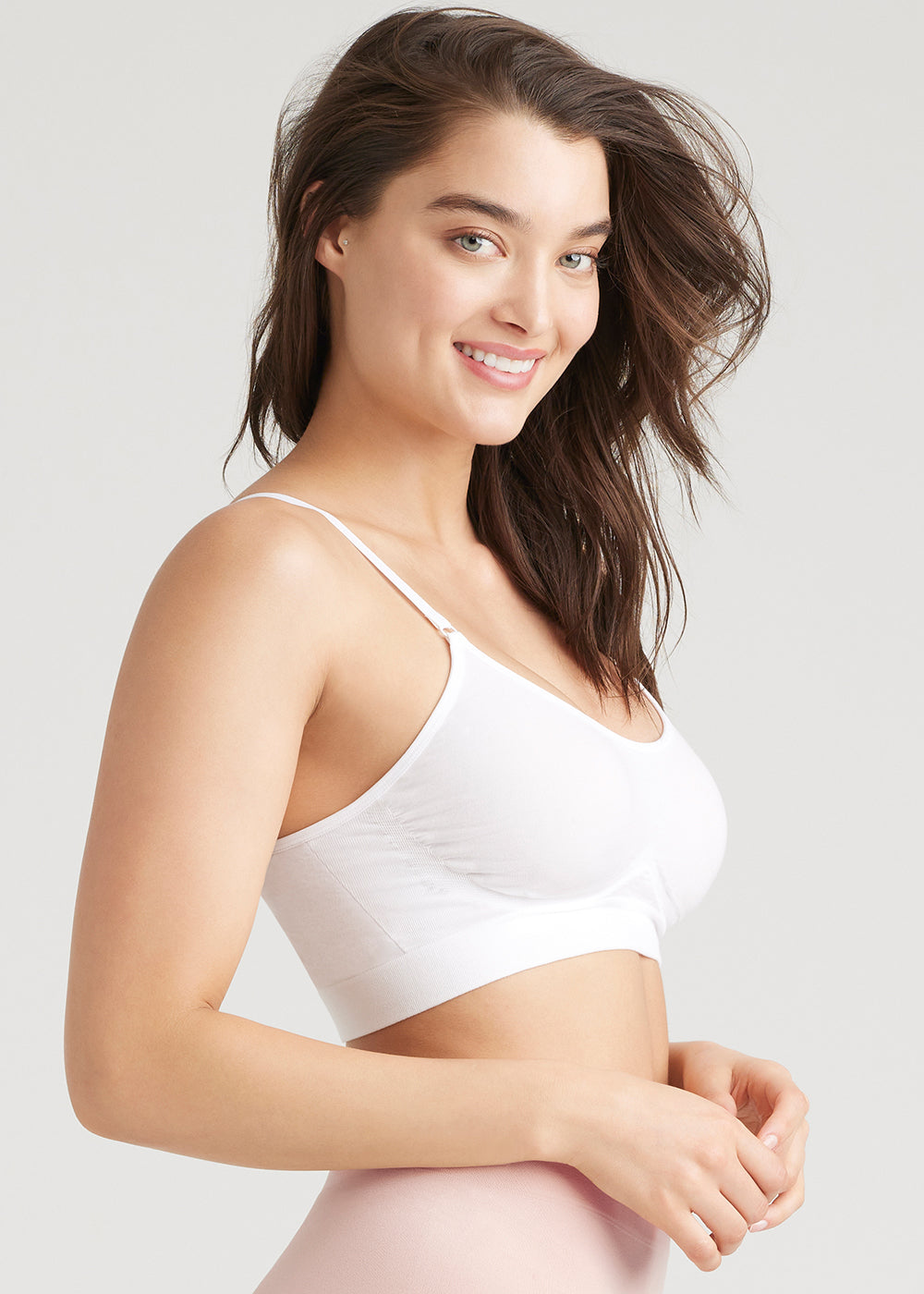 convertible scoop neck unlined bralette - outlast® seamless in White and  non-shaping retro brief - seamless in Rose Smoke worn by a woman standing sideways with arms at waist Yummie