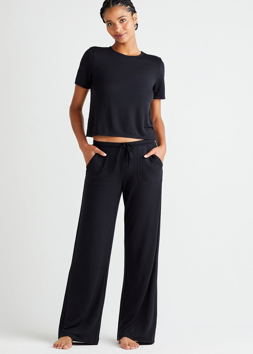 straight leg lounge pant with pockets - baby french terry and peek-a-boo twist back lounge top - baby french terry in Black worn by a woman standing facing forward with hands in pockets Yummie
