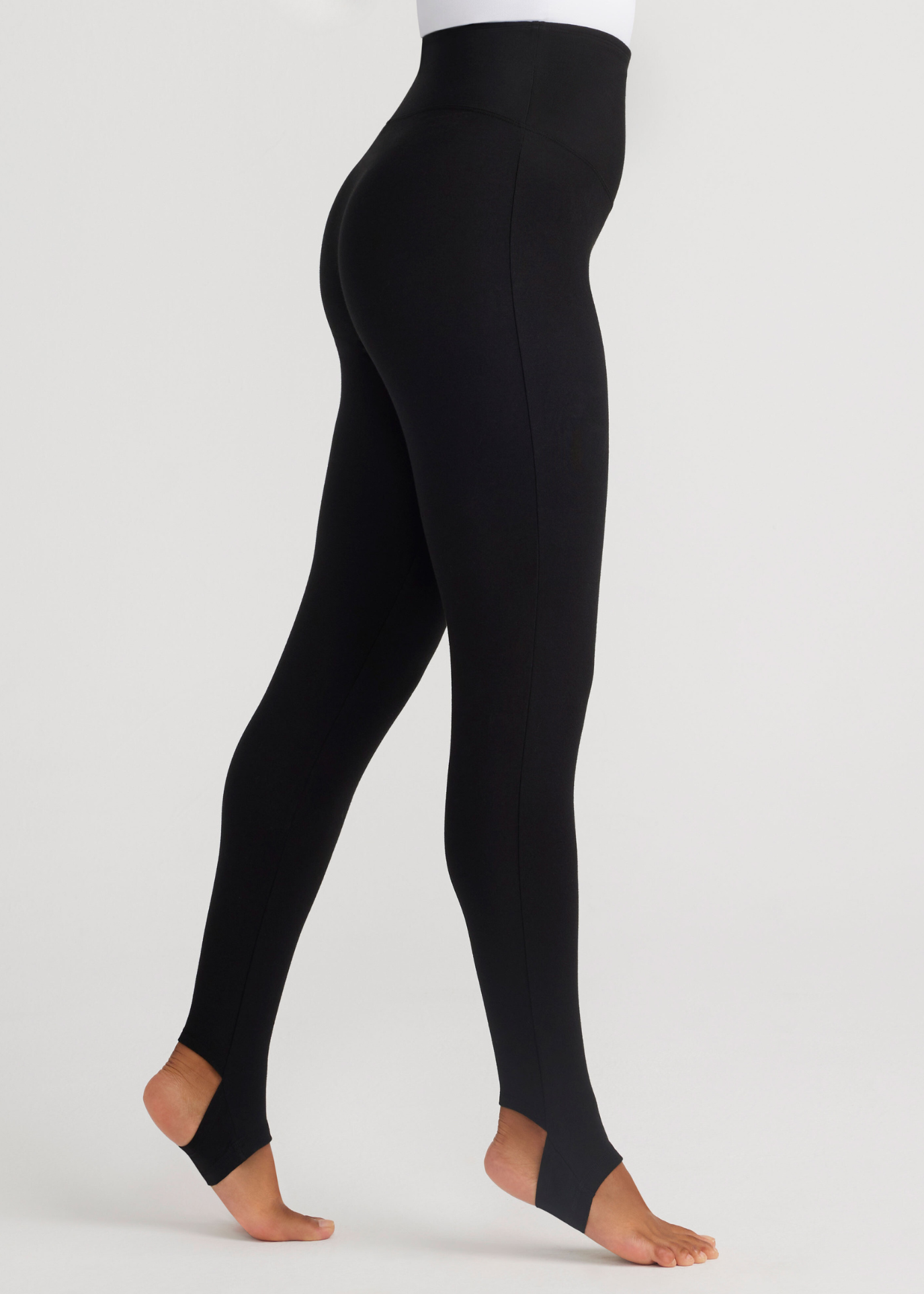 mason stirrup shaping legging - cotton stretch in Black worn by a woman standing sideways Yummie