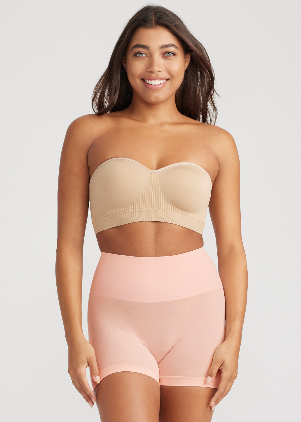 ultralight shaping short - seamless in English Rose and bandeau bra - seamless in Almond worn by girl with hands at sides and facing forward. Yummie.