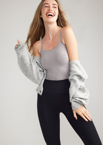 convertible shaping camisole - outlast® seamless in Gull Grey worn by a woman standing with left hand on thigh and right arm bent Yummie