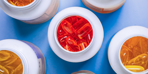 Birds eye view of open pill bottles with colorful pills