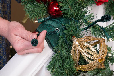 Secure the garland to the Banister Saving Garland Tie