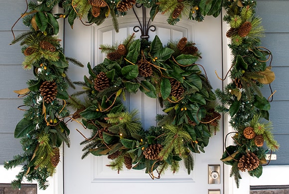 Magnolia Leaf Wreath and Garland Hanging On Front Door