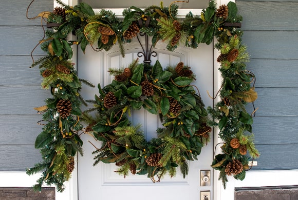 Magnolia Leaf Wreath and Garland Hanging On Front Door