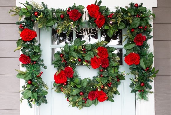 Red Peony & Berry Wreath and Garland Hanging On Front Door