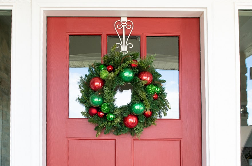 Christmas Cheer Red and Green Wreath Hanging On Front Door