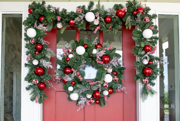 Nordic Red and White Wreath and Garland Hanging On Front Door