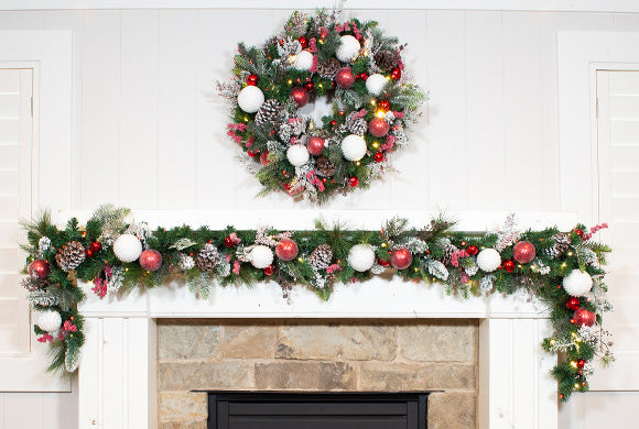 Frosted Wonderland Wreath and Garland Hanging Above Fireplace Mantle