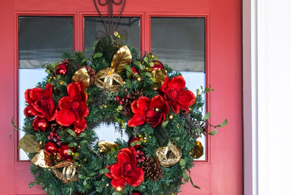 Village Lighting Wreath on Red Door with Nun Chuck™ Battery Pack installed