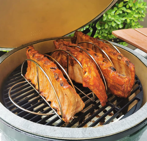 kamado joe stainless steel rack loaded with ribs on top of a griller
