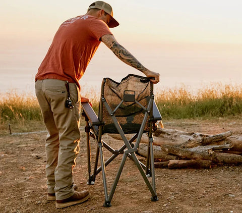 a man setting up a  Yeti Trailhead Camp Chair outdoor