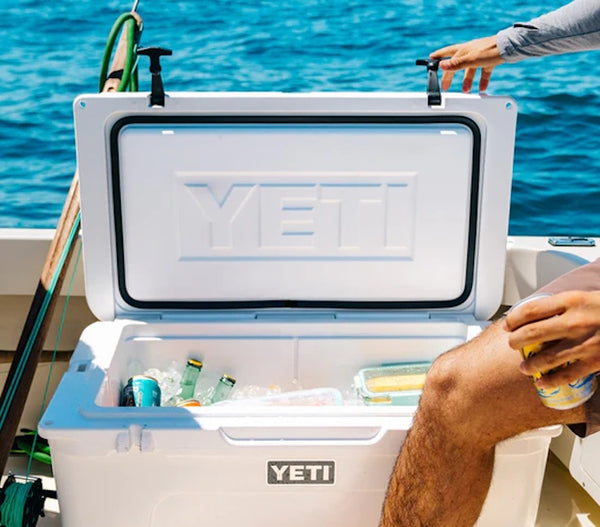 an opened lid white YETI Tundra® 65 Cool Box filled with ice and drinks on a fishing boat