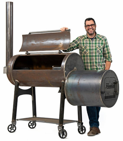 Aaron Franklin standing beside his Offset Smoker Franklin Pit