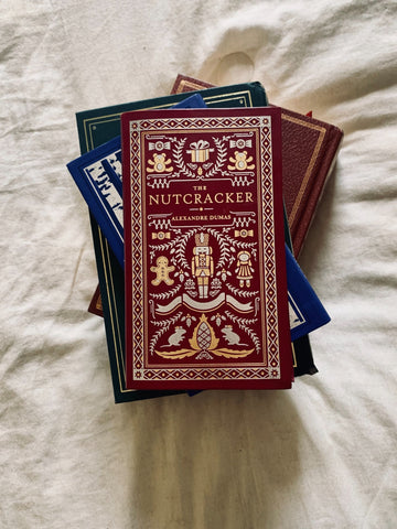 Vintage Aesthetic copy of the Nutcracker in a stack of Christmas books