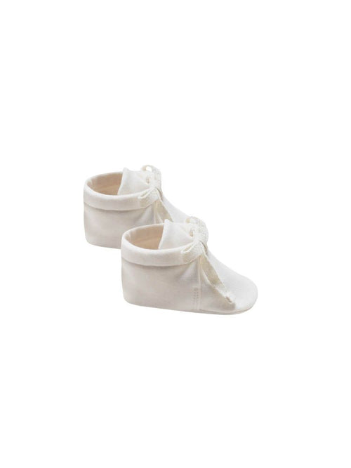 Quincy Mae ivory baby booties against white backdrop