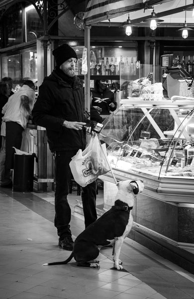 A Florentinian Man and dog shopping at the Sant' Ambrogio market.
