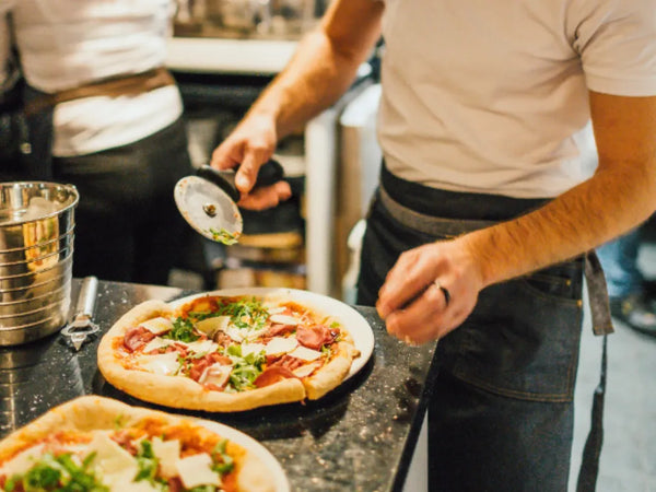 pizza cutter on wooden board