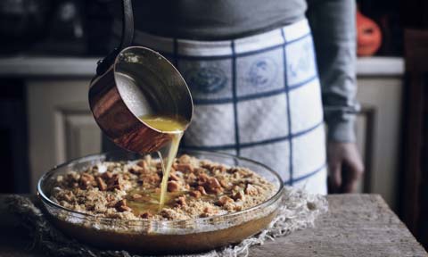 pouring melted butter into baking mixture