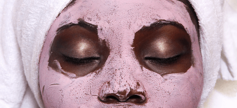 pink skincare mask on woman's face