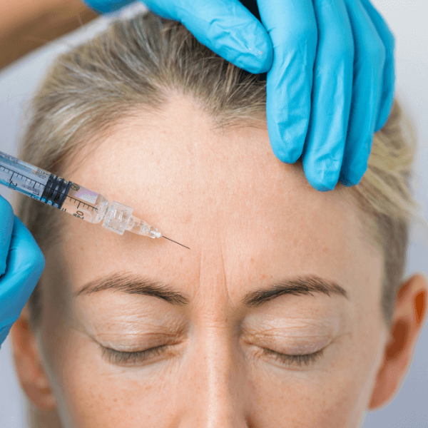 woman getting botox between eyebrows