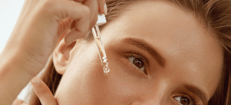 woman applying serum