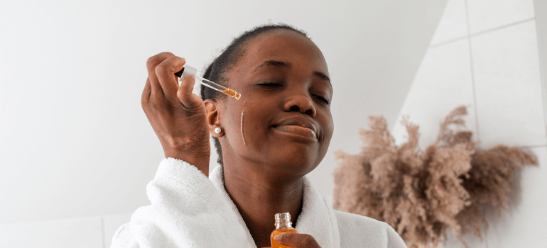 woman applying skin serum