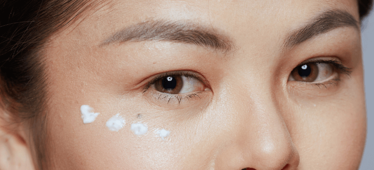 dots of cream under woman's eye