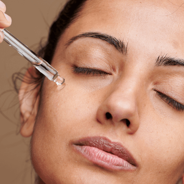 woman applying eye serum