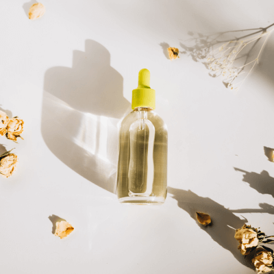 serum surrounded by dried flowers