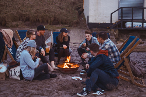 Friends enjoying a campfire along the beach.